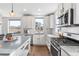 Modern kitchen with white cabinets, granite counters, stainless steel appliances, and hardwood floors at 10031 Town Ridge Ln, Lone Tree, CO 80124