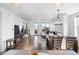 Open-concept living space with a dining area, plush sofa, and access to a balcony at 10031 Town Ridge Ln, Lone Tree, CO 80124