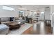 Open concept living space with modern furnishings, connecting kitchen, dining and living areas at 10031 Town Ridge Ln, Lone Tree, CO 80124