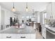 Open-concept kitchen view to dining and living area with modern lighting and hardwood floors at 10031 Town Ridge Ln, Lone Tree, CO 80124