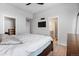 Contemporary design in main bedroom with bathroom access and mounted television at 10031 Town Ridge Ln, Lone Tree, CO 80124