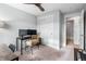 Home office with desk, comfortable seating, and a convenient closet for organized workspace at 10031 Town Ridge Ln, Lone Tree, CO 80124