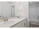 Bathroom featuring double sinks, a quartz countertop, and modern chrome fixtures at 8250 Snake River St, Littleton, CO 80125