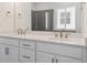 Bathroom featuring double sinks, a quartz countertop, and modern chrome fixtures at 8250 Snake River St, Littleton, CO 80125