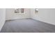 A spacious bedroom with large windows offering plenty of natural light and neutral carpet at 8250 Snake River St, Littleton, CO 80125