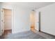 A bright bedroom featuring neutral walls, carpet, and two entry doors at 8250 Snake River St, Littleton, CO 80125