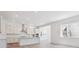 Modern, all-white kitchen featuring stainless steel appliances, large island, and ample counter space at 8250 Snake River St, Littleton, CO 80125