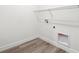 Efficient laundry room with modern wood-look flooring and essential hookups for appliances at 8250 Snake River St, Littleton, CO 80125
