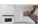 A cozy living area featuring a fireplace and staircase with rich, dark wood railing at 8250 Snake River St, Littleton, CO 80125
