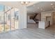 Bright living room with light wood floors, modern lighting and sliding glass doors to patio at 8250 Snake River St, Littleton, CO 80125