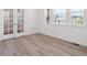 Bright study with hardwood floors, large windows, and glass doors for a professional home office at 8250 Snake River St, Littleton, CO 80125