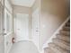 Inviting entryway featuring neutral paint, tile flooring, and a staircase with carpeted steps at 3262 E 103Rd Dr # 1806, Thornton, CO 80229