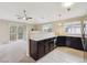 Open kitchen with dark cabinets, light countertops, and stainless steel appliances at 3262 E 103Rd Dr # 1806, Thornton, CO 80229