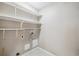A utility room with shelving, electrical and water hookups for washer and dryer at 3262 E 103Rd Dr # 1806, Thornton, CO 80229