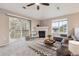 Cozy living room with a fireplace, a sliding glass door to a balcony, and a large window at 3262 E 103Rd Dr # 1806, Thornton, CO 80229
