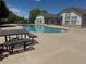 An inviting community pool features lounge chairs and tables for relaxing, with building nearby at 3262 E 103Rd Dr # 1806, Thornton, CO 80229