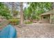 This backyard offers rock landscaping, mature trees, a deck, and a boat at 4858 S Queen St, Littleton, CO 80127