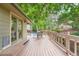 A deck area features outdoor seating and shade from mature trees at 4858 S Queen St, Littleton, CO 80127