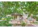 An outdoor deck is surrounded by mature trees and landscaping at 4858 S Queen St, Littleton, CO 80127