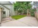 This backyard offers a patio, landscaping, and mature trees at 4858 S Queen St, Littleton, CO 80127