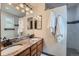 Bathroom featuring double vanity, granite counter, and tile flooring, offering modern luxury at 4858 S Queen St, Littleton, CO 80127