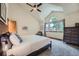 Bright bedroom with vaulted ceilings, ceiling fan, and a large window providing natural light at 4858 S Queen St, Littleton, CO 80127