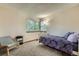This bedroom features carpet, a chair, and a large window at 4858 S Queen St, Littleton, CO 80127