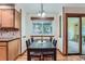 Bright dining area with a dark table and views of the backyard through a large window at 4858 S Queen St, Littleton, CO 80127