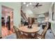 Charming dining area with a wooden table, complemented by living room with vaulted ceilings at 4858 S Queen St, Littleton, CO 80127