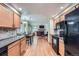 Well-appointed kitchen featuring modern appliances, granite countertops, and hardwood flooring at 4858 S Queen St, Littleton, CO 80127