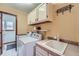 Well-equipped laundry room offering ample space, storage cabinets, a utility sink, and washer/dryer hookups at 4858 S Queen St, Littleton, CO 80127