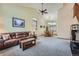 Open-concept living room featuring vaulted ceilings, neutral carpeting, and lots of natural light at 4858 S Queen St, Littleton, CO 80127
