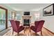 Cozy living room featuring a brick fireplace, hardwood floors, and comfortable seating at 4858 S Queen St, Littleton, CO 80127