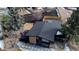 Aerial view of a modern house with a well-maintained yard, stylish black exterior, and lush landscaping at 1390 S Jasmine Way, Denver, CO 80224