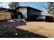 Large backyard featuring a wood fence, covered parking and a lush green lawn ready for outdoor activities at 1390 S Jasmine Way, Denver, CO 80224