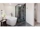 Modern bathroom featuring a freestanding tub and glass-enclosed shower with stylish fixtures and tile work at 1390 S Jasmine Way, Denver, CO 80224