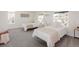 Bright bedroom showcasing two beds, soft carpet, and an abundance of natural light from multiple windows at 1390 S Jasmine Way, Denver, CO 80224