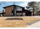 Contemporary home with a well-maintained front yard and modern design elements at 1390 S Jasmine Way, Denver, CO 80224