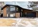 Beautiful contemporary home featuring a modern garage door and manicured yard at 1390 S Jasmine Way, Denver, CO 80224