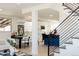 Open-concept living space featuring a dining area, a modern kitchen, and staircase with black metal railings at 1390 S Jasmine Way, Denver, CO 80224