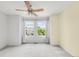 Light bedroom features large windows providing ample natural light and a ceiling fan at 9369 Longs Peak Dr, Commerce City, CO 80640