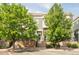 Charming townhouse featuring lush green trees, and a welcoming front entrance at 9369 Longs Peak Dr, Commerce City, CO 80640