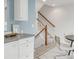 Kitchen and dining area with white cabinets, gray counters, and stairs visible at 9369 Longs Peak Dr, Commerce City, CO 80640