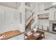 Open-concept living space with staircase, fireplace, and modern decor, creating a welcoming and stylish home interior at 9369 Longs Peak Dr, Commerce City, CO 80640