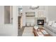 Cozy living room with a fireplace, open shelving, decor, and staircase access in a bright, airy interior at 9369 Longs Peak Dr, Commerce City, CO 80640