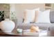Close-up of a cozy living room featuring a comfortable sofa, stylish decor, and warm, inviting ambiance at 9369 Longs Peak Dr, Commerce City, CO 80640