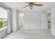Serene main bedroom boasts neutral tones, a ceiling fan, and an en-suite bathroom at 9369 Longs Peak Dr, Commerce City, CO 80640