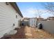 Fully fenced backyard with garden shed, and stone walkway leading to the backyard at 8155 W Tennessee Dr, Lakewood, CO 80226