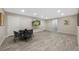 Finished basement with a dining table set and TV screen at 8155 W Tennessee Dr, Lakewood, CO 80226