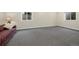 Spacious basement with carpeted flooring and a comfortable sofa by the window at 8155 W Tennessee Dr, Lakewood, CO 80226